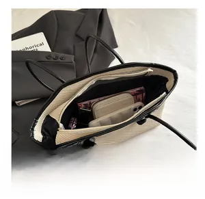 Top view of beige woven tote bag interior showing large capacity and inner pockets