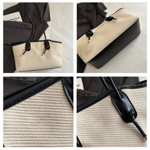 Detail view of woven fabric texture and black leather trim with gold metal hardware