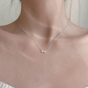 Elegant s925 silver bow necklace with micro-set zircon stones worn on neck
