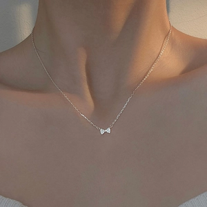 Elegant S925 sterling silver bowknot necklace with zircon stones on a female model