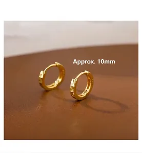 Detailed macro view of 10mm geometric S925 sterling silver gold plated hoop earrings