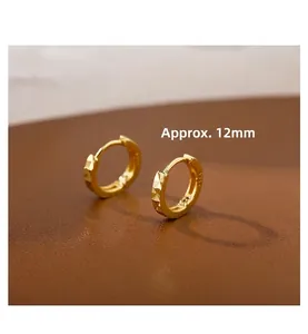 Macro view of 12mm geometric faceted gold hoop earrings with S925 hallmark