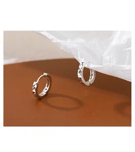 Detail view of 10mm geometric silver hoop earrings showing the S925 hallmark stamp