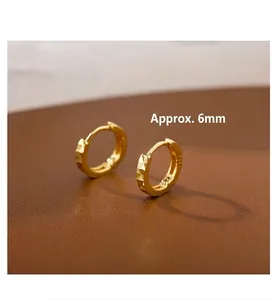 Close-up of golden geometric rhombic pattern earrings in 925 silver, 6mm small hoop style
