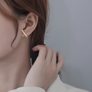 Elegant gold X-shaped crisscross stud earrings for women with shimmering pavé crystal details
