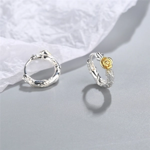 Vintage silver vine hoop earrings with gold rose detail shown on a minimal background