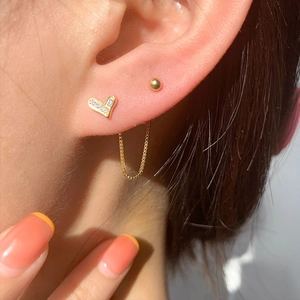 Elegant gold heart earrings set with zircon studs and a delicate thin chain link