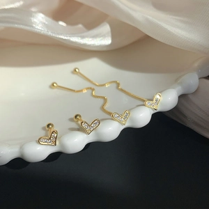Detail of S925 silver heart stud and fringe drop earrings with sparkling pavé zircons