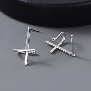Minimalist S925 sterling silver geometric cross stud earrings on a cool grey background
