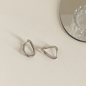 Irregular silver twisted hoop earrings with a polished mirror finish for a modern look