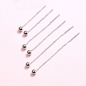 Detailed view of S925 sterling silver drop threader earrings with small ball pendants