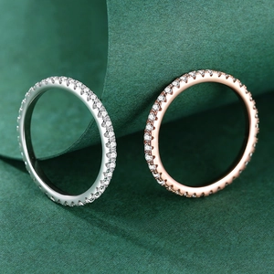 Eternity rings in silver and rose gold finishes with micro-pave moissanite stones