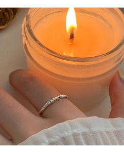 Macro shot of S925 sterling silver Luck letter ring with vintage twisted design