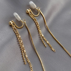 Elegant gold multi-strand tassel clip-on earrings with soft white silicone pads