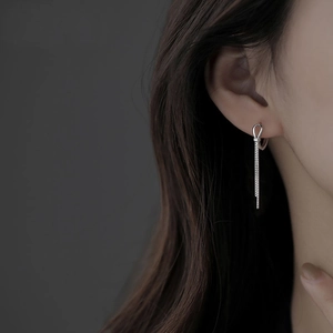 Elegant S925 sterling silver knot tassel drop earrings worn by model on grey background