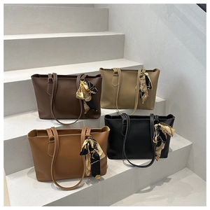 Detail view of large soft leather tote bags in four colors with decorative silk scarves