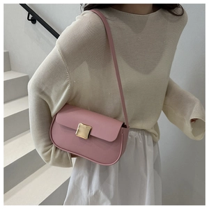 Detailed shot of pink faux leather underarm bag with a premium gold square buckle clasp