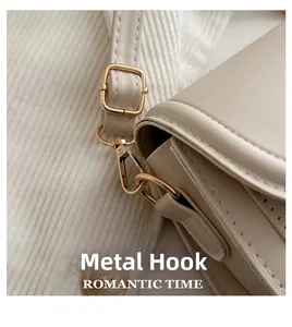 Detail of light beige leather bag showing fine stitching and durable gold metal hook