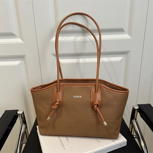Brown woven tote bag with FASHION logo and knotted leather handles for women