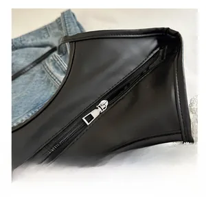 Detail shot of smooth silver metal zipper on high-quality black faux leather bag