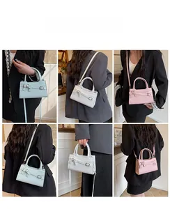 Detail view of various bow-accented crossbody bags in light blue, pink and white