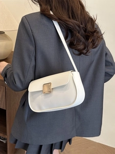 Chic white leather shoulder bag with gold buckle worn by model in minimalist suit