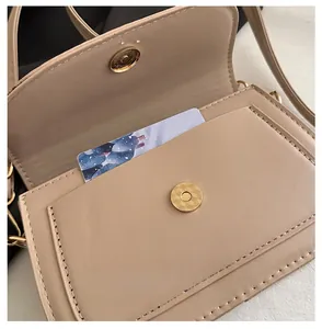 Close-up of magnetic snap closure and card slot design on beige PU leather flap bag