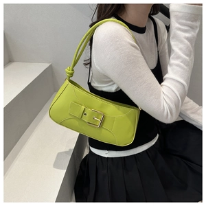 Detail of bright green underarm bag with silver buckle and knotted shoulder strap