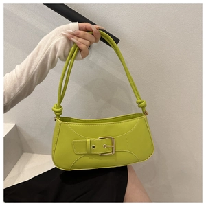 Detail of neon green crossbody bag with golden buckle and stylish knotted shoulder strap