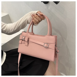Pink crossbody square bag with a decorative bow and silver metal buckle detail