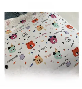 Detailed macro view of woven fabric texture with vintage bear patterns and sweet typography