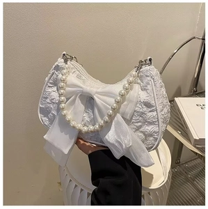 White crinkled underarm bag with large satin bow and pearl handle for women