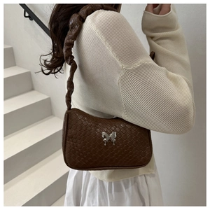 Detail of a brown woven texture shoulder bag featuring a silver butterfly buckle