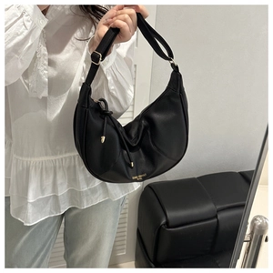 Detail of black crescent shoulder bag with lychee texture leather and gold zipper