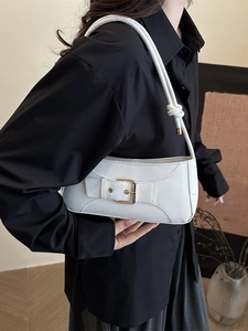 Chic white minimalist shoulder bag with gold clasp and slim strap shown on model