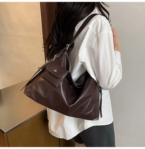 Detail of a large dark brown PU leather tote bag with a matching detachable chain pouch