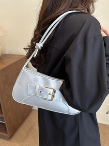 Elegant metallic silver satin underarm bag with gold buckle and stylish knotted strap design