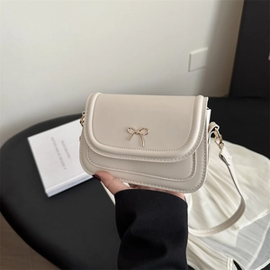 Chic cream bow knot square crossbody bag with gold hardware and leather strap