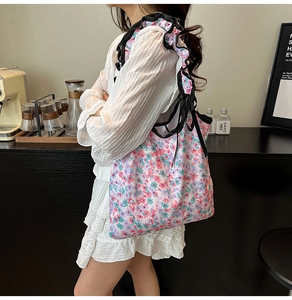 Detailed shot of floral canvas tote bag with black ruffle strap and lifestyle scene