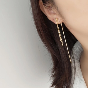 Elegant gold long tassel drop earrings with bead chain and sleek metal bars on model