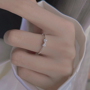 Minimalist S925 sterling silver bow ring with shimmering pavé diamonds on finger