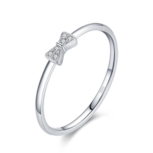 Polished S925 silver bow ring with sparkling pavé cubic zirconia on white background