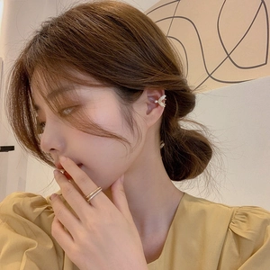 Elegant gold butterfly ear cuff with pearls and zircons on model with gold rings