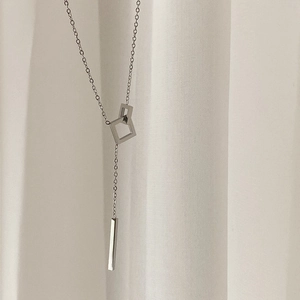 Minimalist Y-shaped geometric necklace with interlocking squares and polished bar pendant
