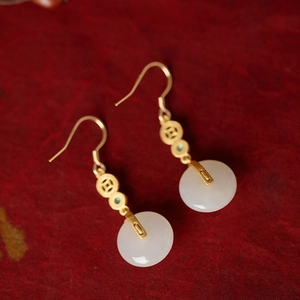 Detailed view of Chinese peace buckle earrings with white jade and gold coin accents