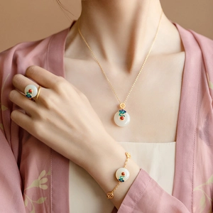 Classical Chinese jewelry set with white jade and enamel clouds on model in pink dress