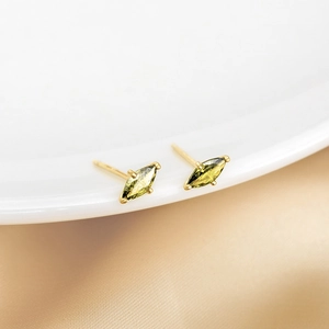 S925 silver olive green marquise stud earrings in gold plating on silk background
