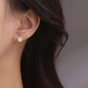 Elegant s925 silver hollow camellia hoop earrings in gold finish worn by a model