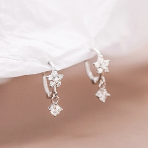 Close-up of S925 silver star earrings with pavé cubic zirconia and crystal drops