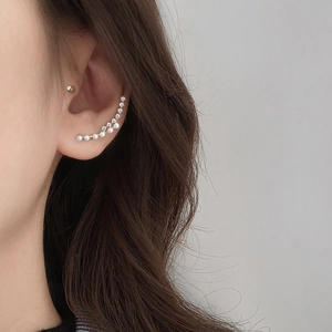 Elegant double row ear crawler featuring pearls and zircon accents on a model's ear
